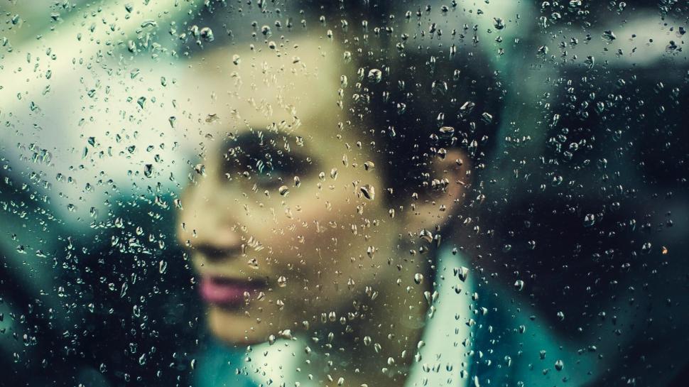 Free Image of Woman Behind Rainy Window 