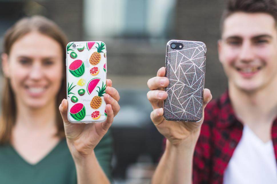 Free Image of Young People Holding Smart Phones 