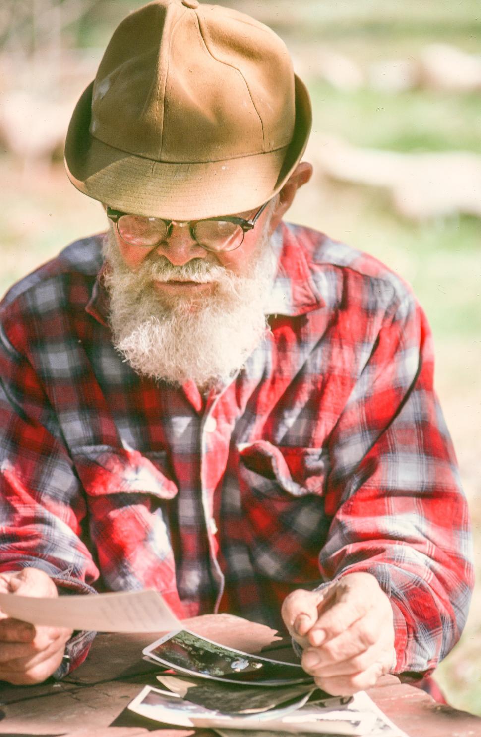 Free Image of Bearded man watching pictures 