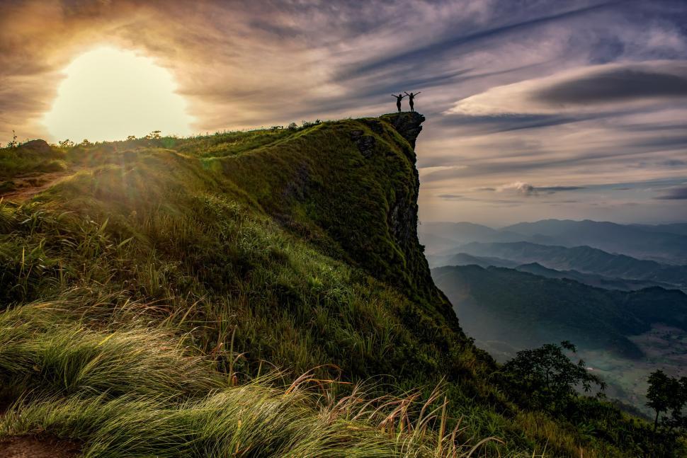 Free Image of Person Standing on Top of Lush Green Hillside 
