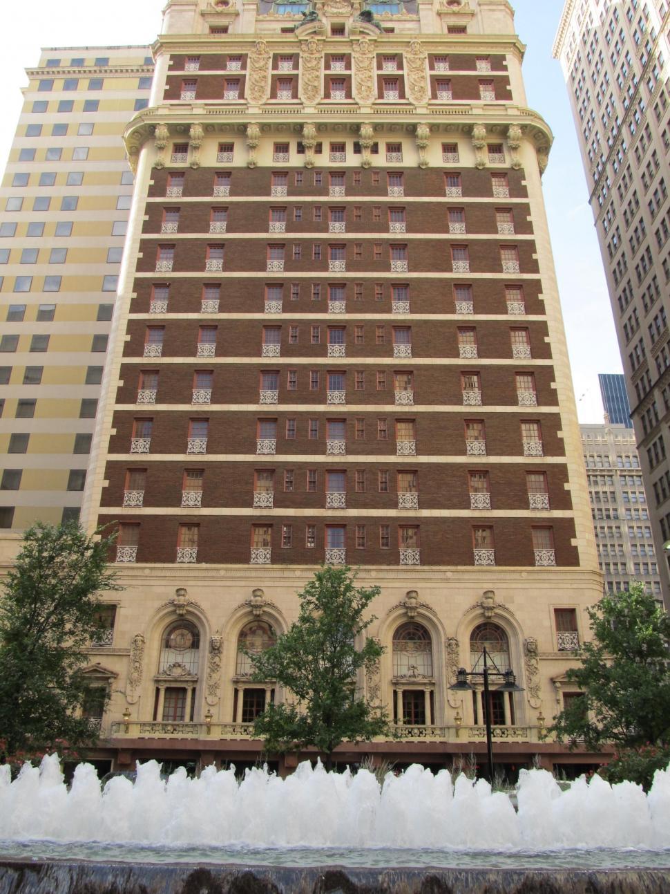 Free Image of Tall Building With Fountain in Front 