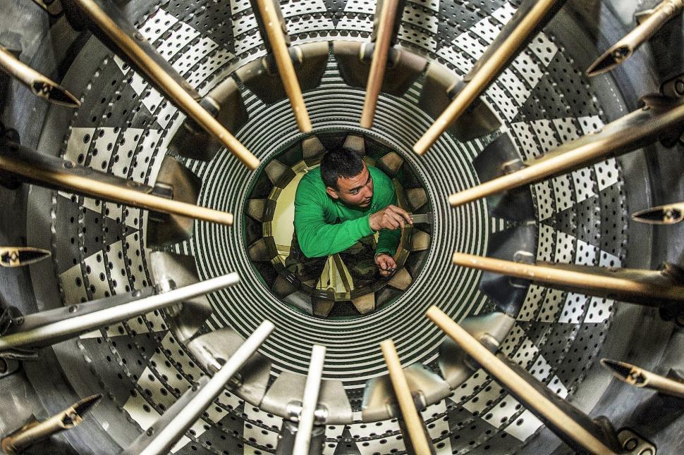 Free Image of Man Sitting Inside Green Shirt in Machine 