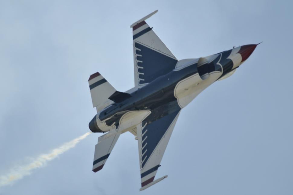 Free Image of Fighter Jet Flying Through Cloudy Sky 