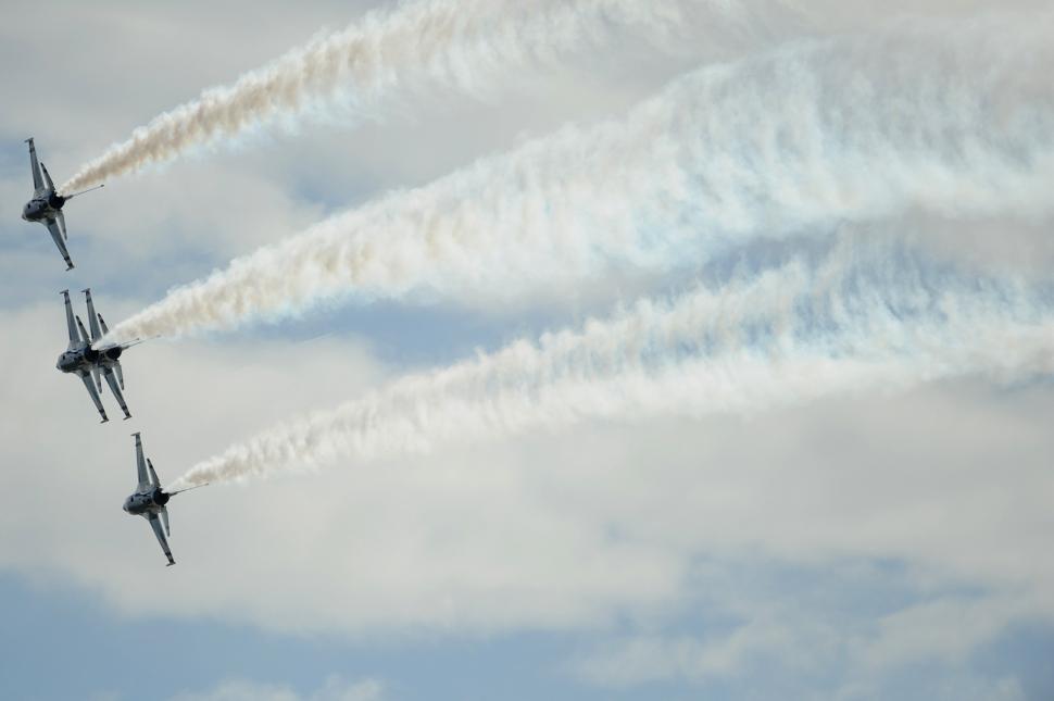 Free Image of Formation of Fighter Jets Flying Through Cloudy Sky 