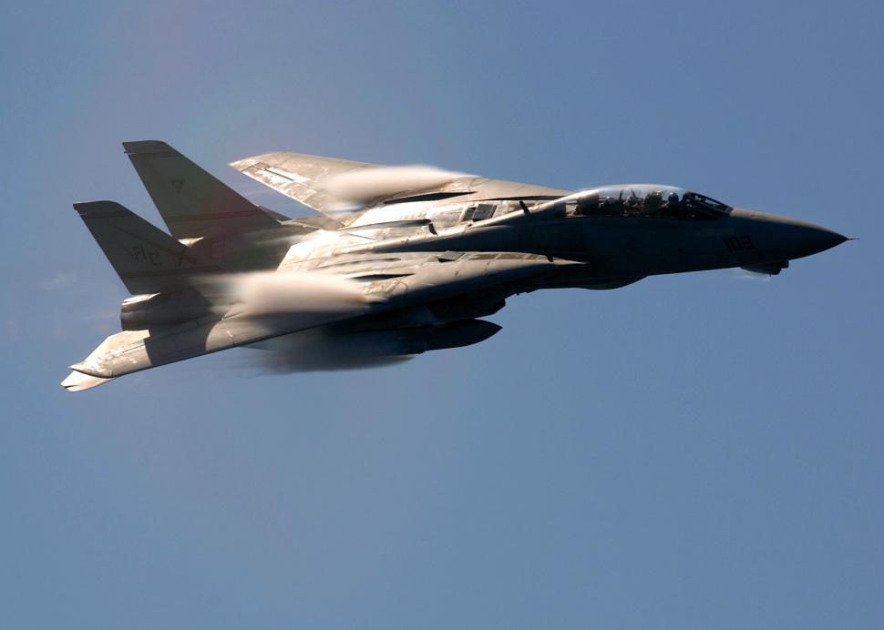 Free Image of Fighter Jet Flying Through a Blue Sky 