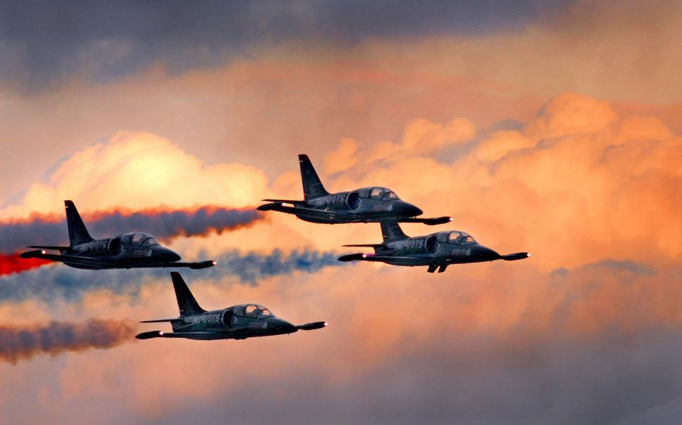 Free Image of Fighter Jets Flying Through Cloudy Sky 