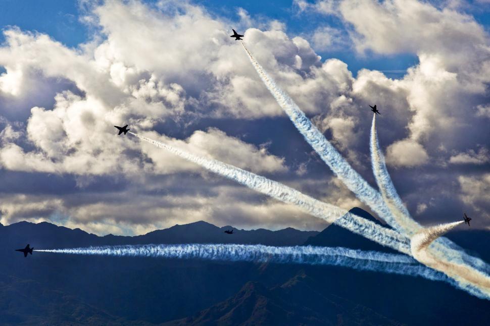 Free Image of Group of Airplanes Flying Through Cloudy Sky 