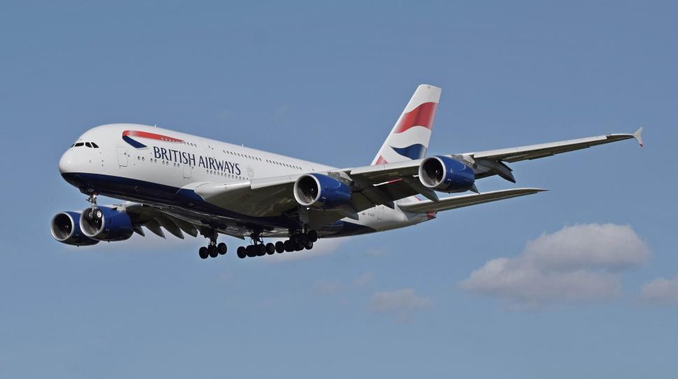 Free Image of Large Jetliner Flying Through Blue Sky 