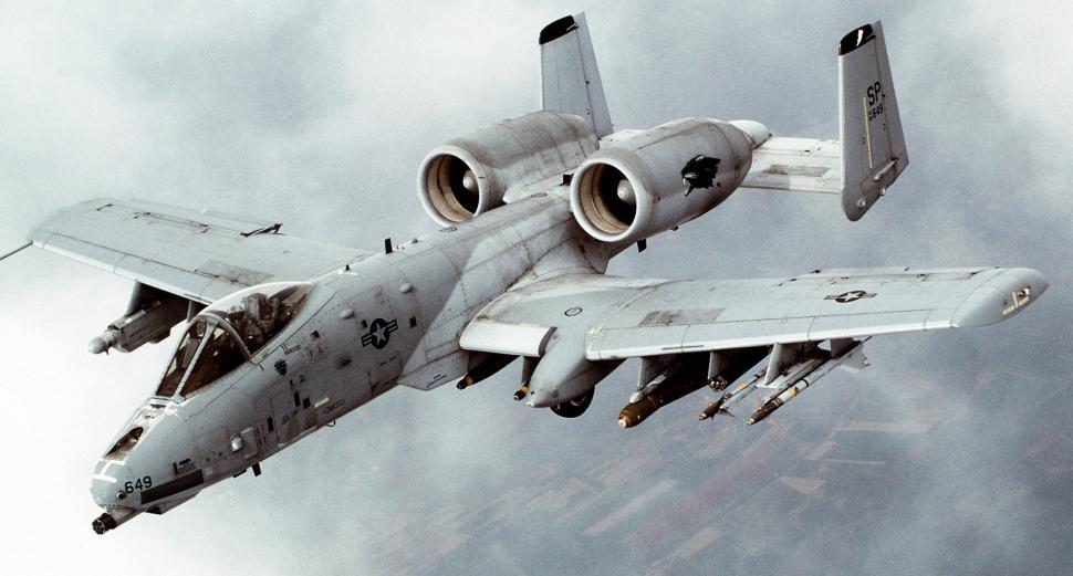 Free Image of Fighter Jet Flying Through Cloudy Sky 