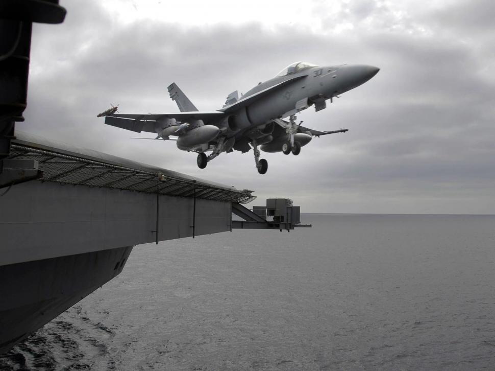 Free Image of Airplane Flying Over Water Near Ship 