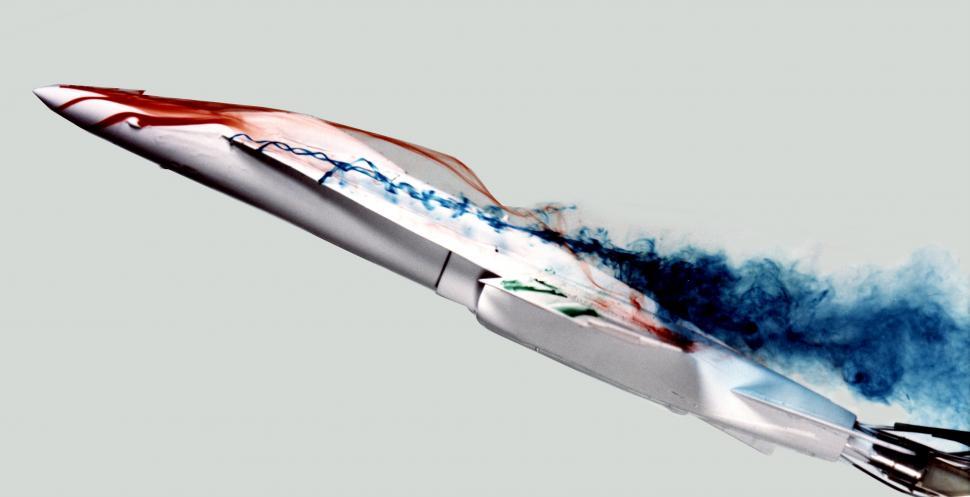 Free Image of Jet Flying Through Air With Blue Smoke 