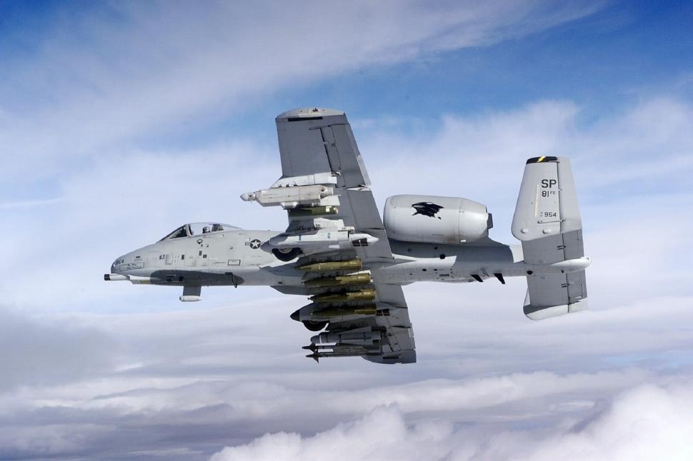 Free Image of Fighter Jet Flying Through Cloudy Blue Sky 