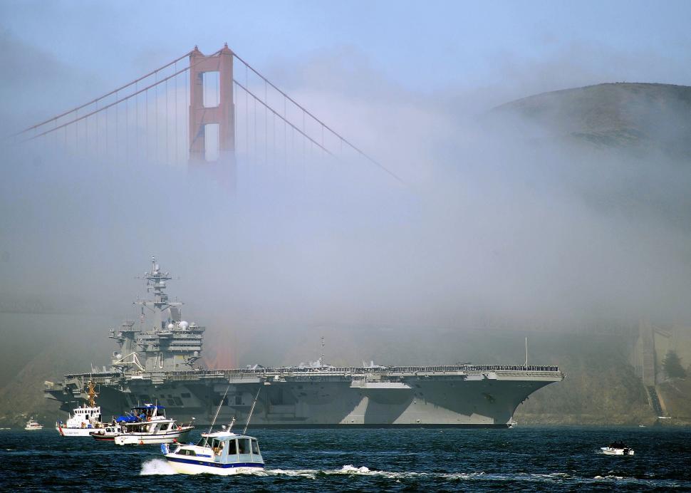 Free Image of Large Ship Passing Under Bridge 