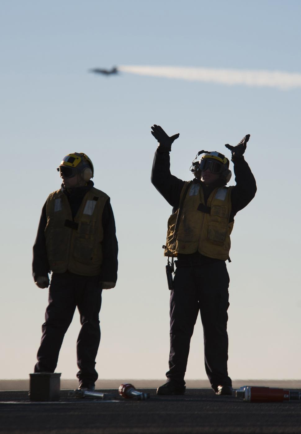 Free Image of Two Men Standing Next to Each Other 