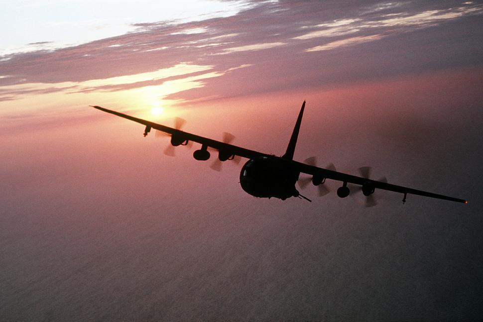 Free Image of Large Airplane Flying Through Cloudy Sky 