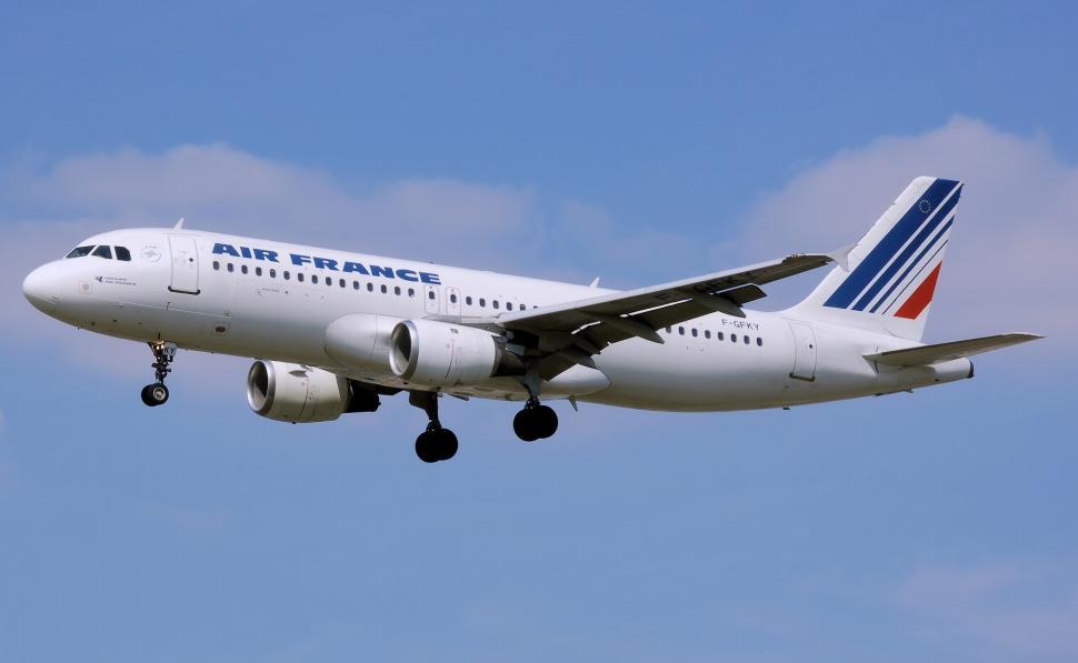 Free Image of Large Passenger Jet Flying Through Blue Sky 