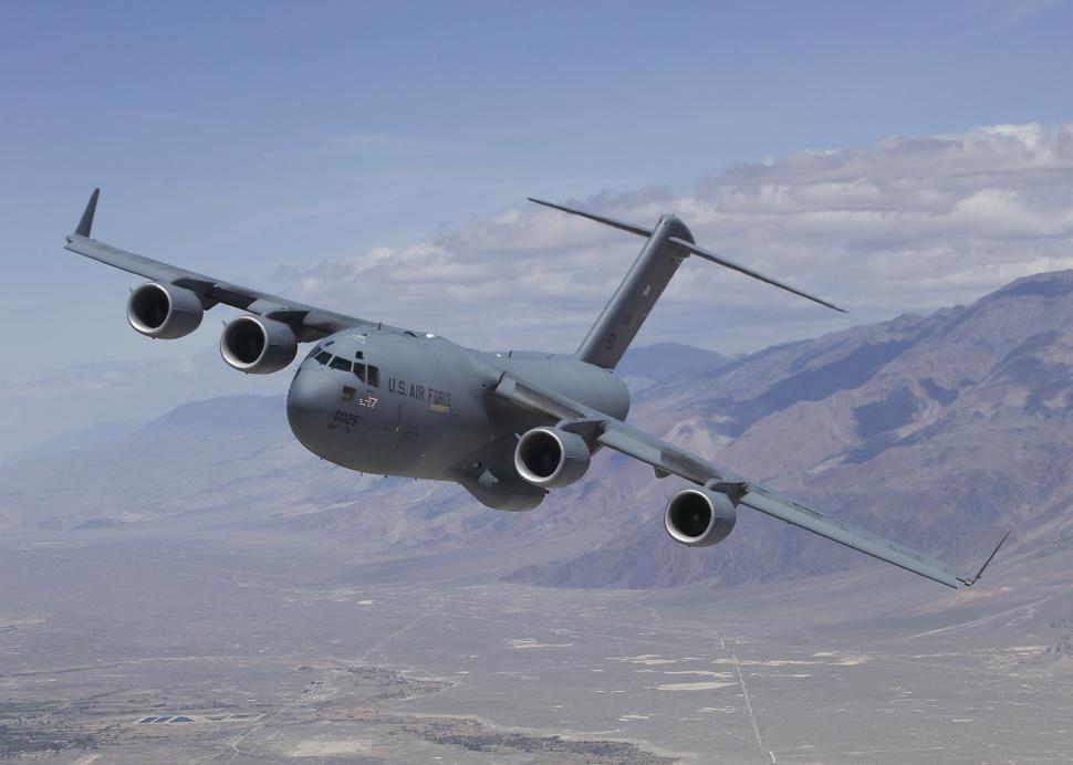 Free Image of Large Airplane Flying Over Mountain Range 