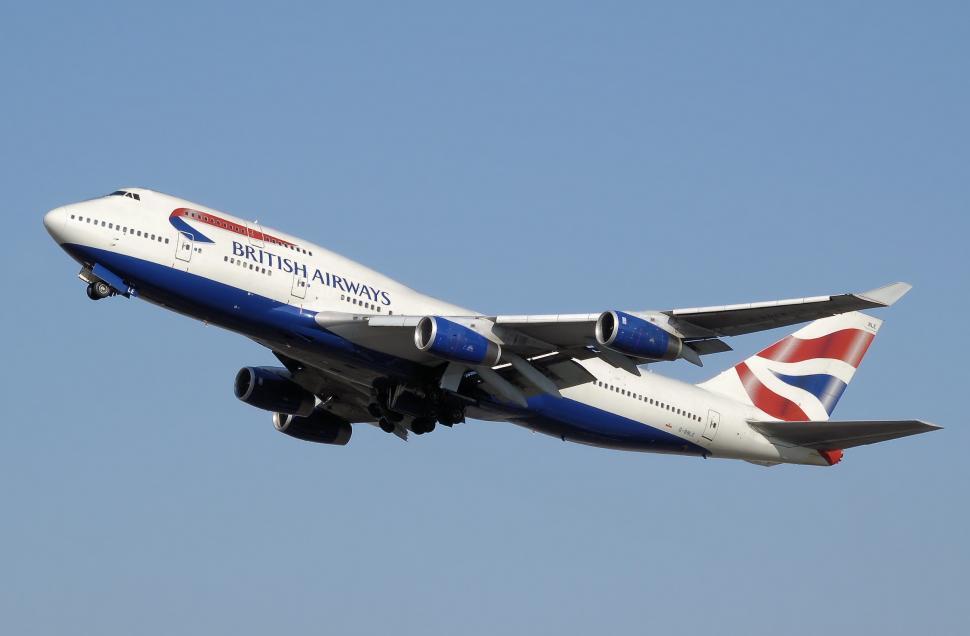 Free Image of Large Jetliner Flying Through Blue Sky 