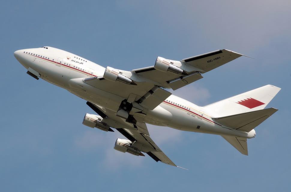Free Image of Large Jetliner Flying Through Blue Sky 