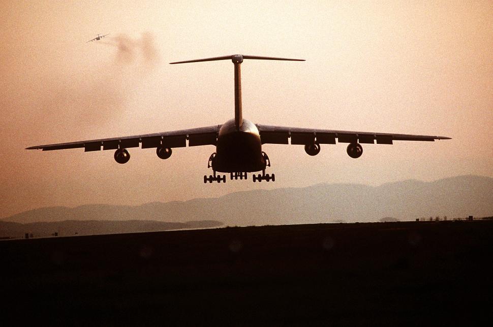 Free Image of Large Jetliner Flying Through Cloudy Sky 