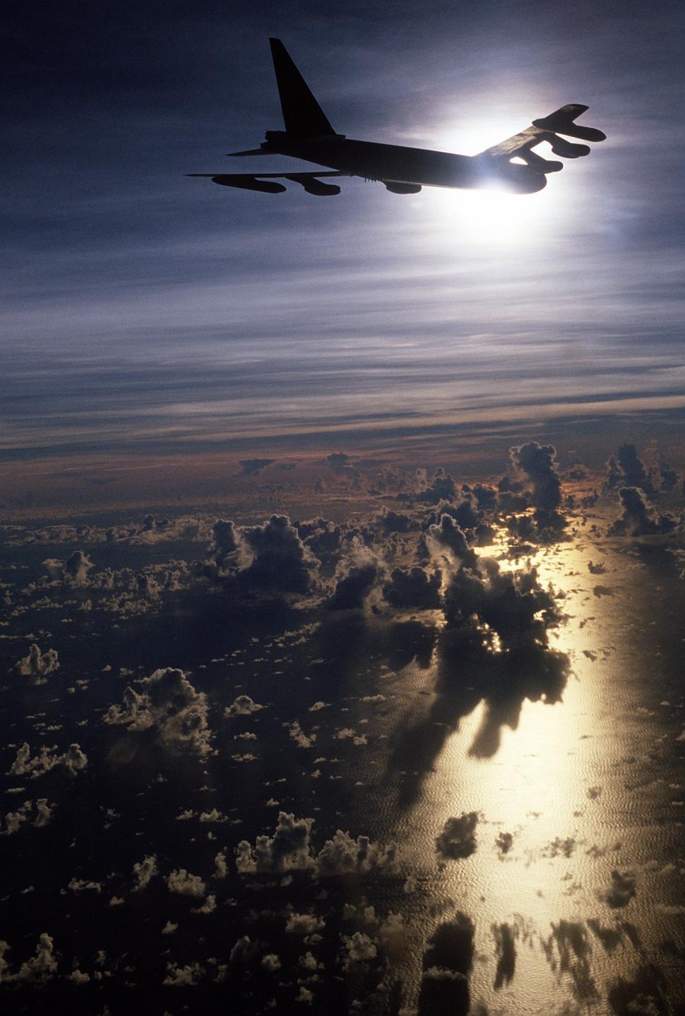 Free Image of Airplane Flying Over Ocean Under Cloudy Sky 