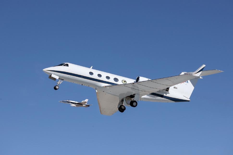Free Image of Small Plane Flying Through Blue Sky 