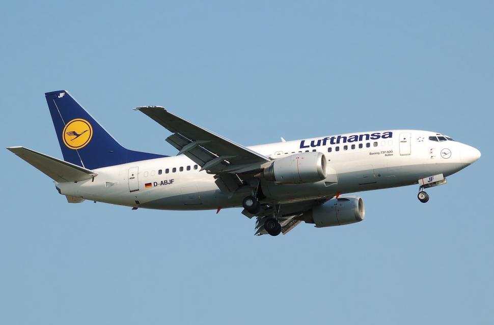 Free Image of Large Jetliner Flying Through Blue Sky 
