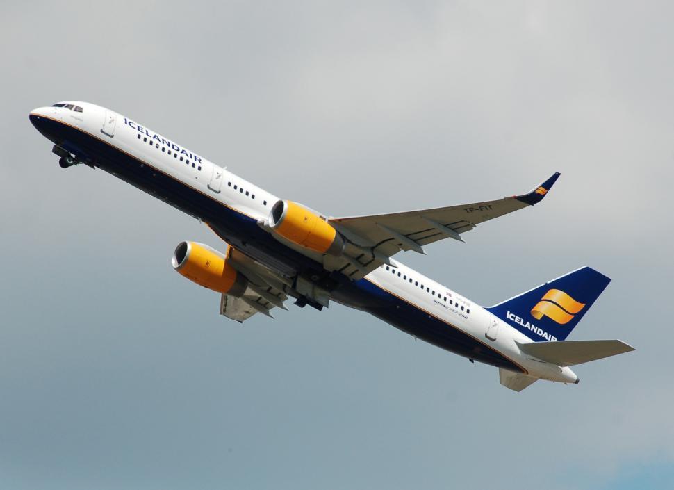 Free Image of Large Jetliner Flying Through Cloudy Sky 