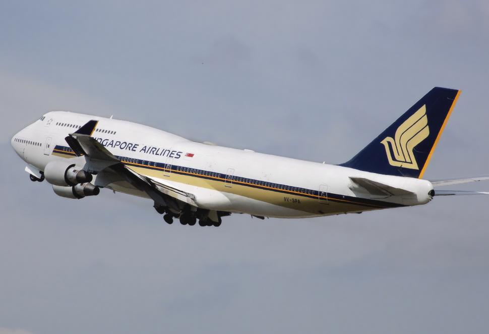 Free Image of Large Jetliner Flying Through Cloudy Sky 