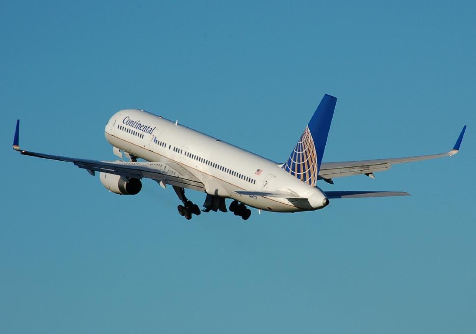 Free Image of Large Jetliner Flying Through Blue Sky 