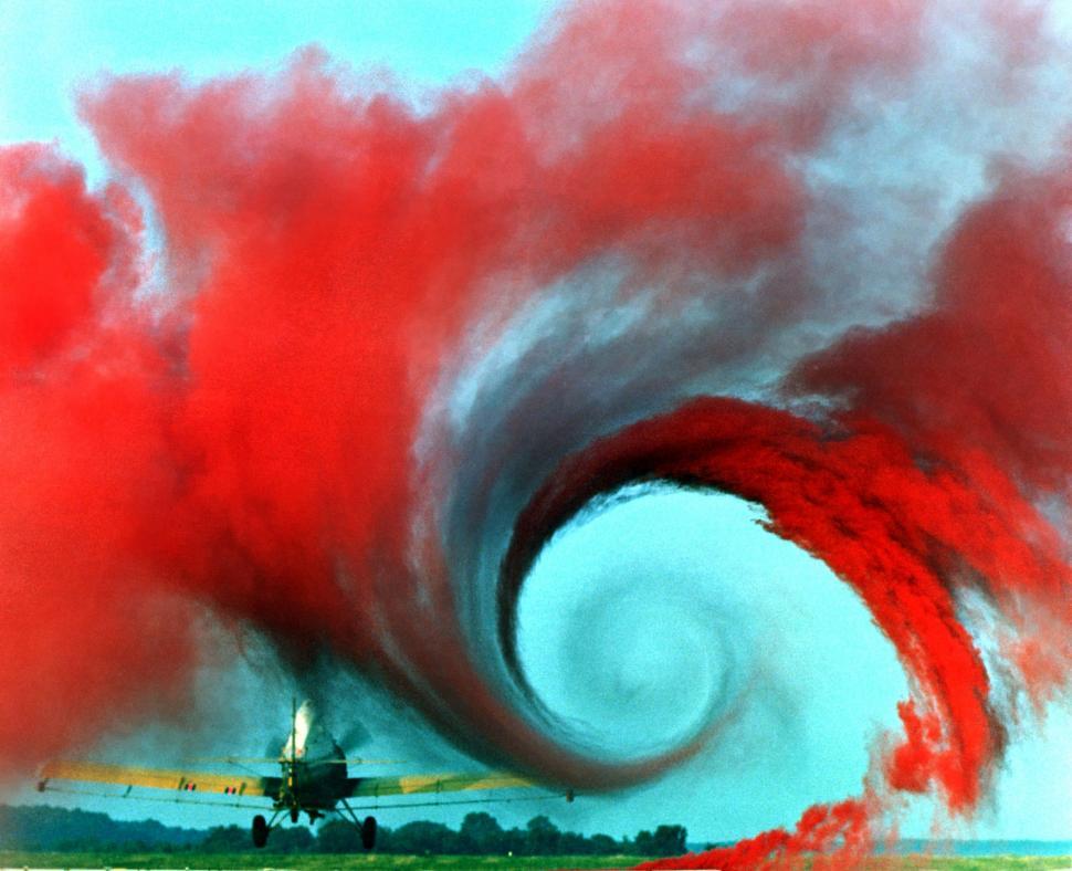 Free Image of Large Red Cloud of Smoke Emanating From Plane 