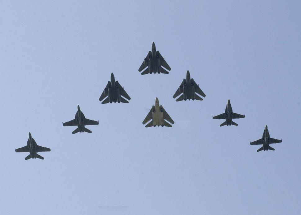 Free Image of Group of Fighter Jets Flying Through Blue Sky 