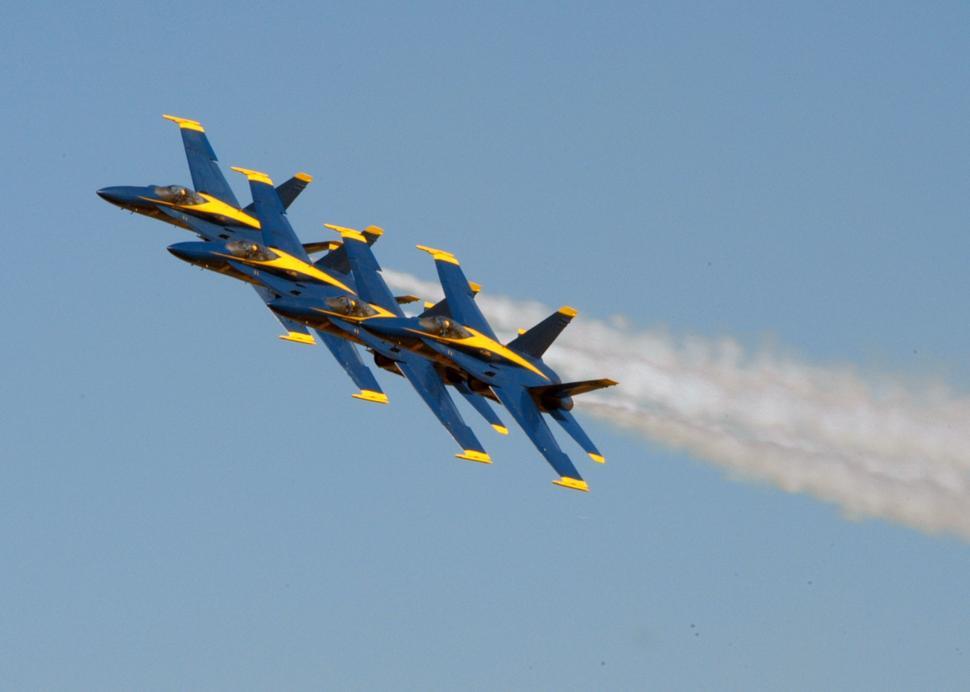Free Image of Group of Fighter Jets Flying Through Blue Sky 