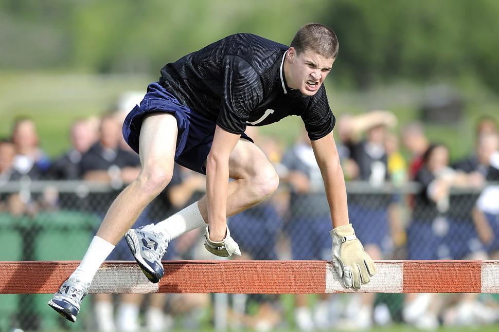 Free Image of Man in Black Shirt and White Shorts Running on Track 