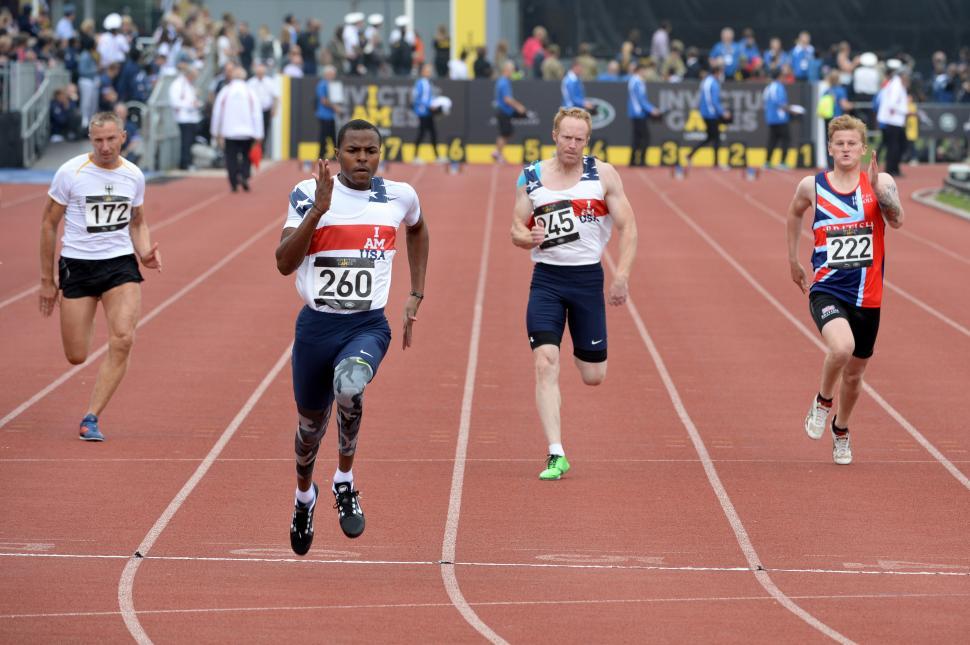 Free Image of Group of Men Running Across Track 