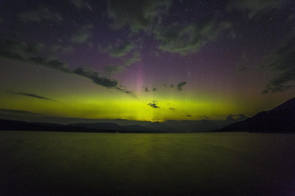 Free Image of Green and Purple Sky Reflecting on Body of Water 