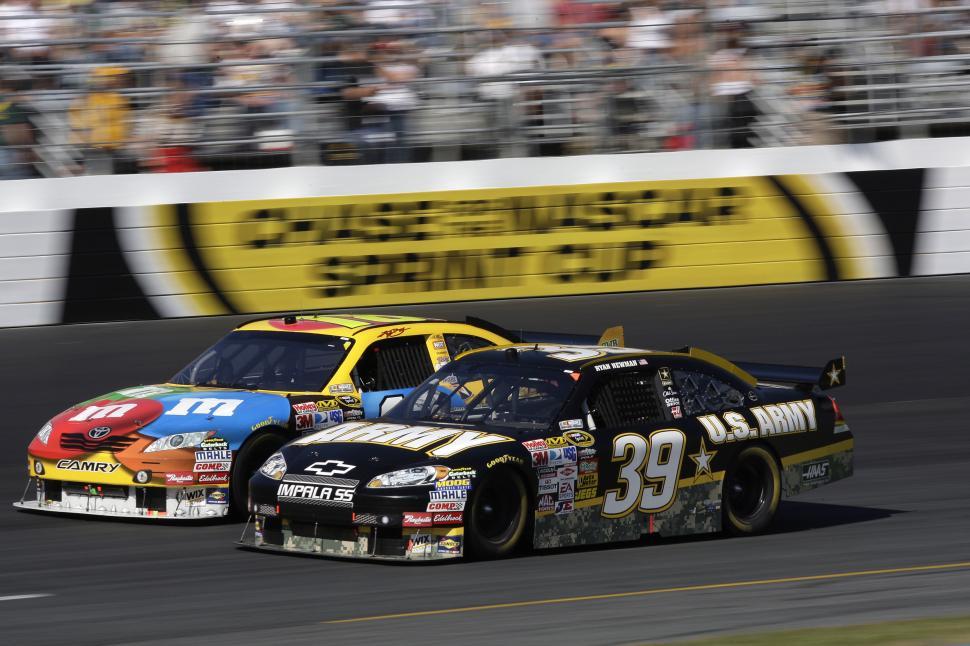 Free Image of Two Cars Racing on a Track 