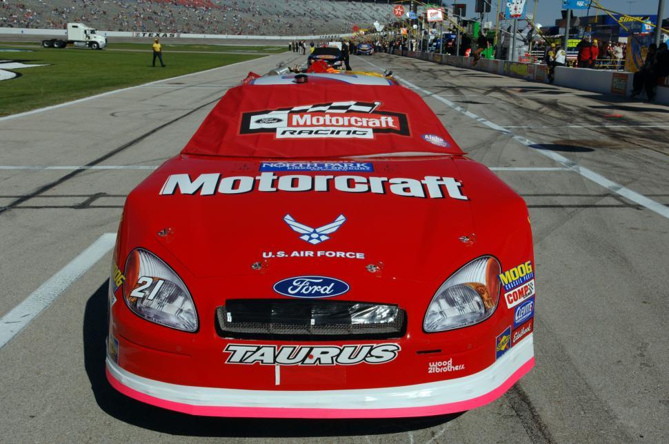 Free Image of Red Race Car Speeding Down Race Track 