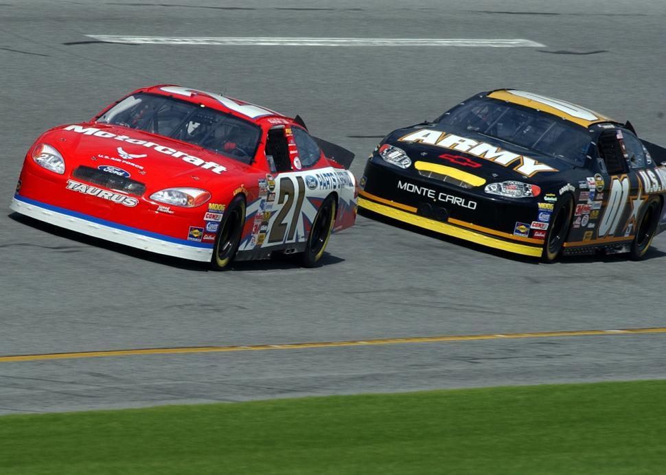 Free Image of Two Cars Racing on a Track 