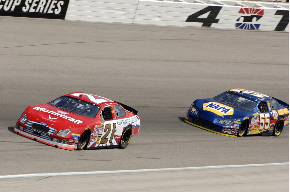 Free Image of Two Cars Racing on a Track 