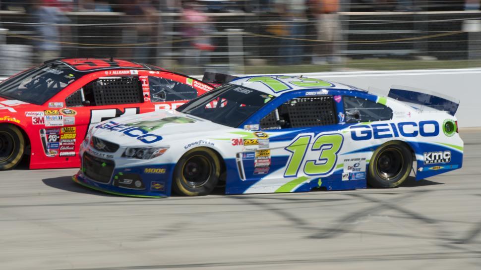 Free Image of Two Cars Racing on a Track 
