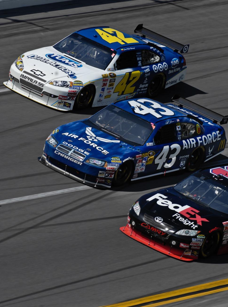 Free Image of Two Cars Racing on a Track 