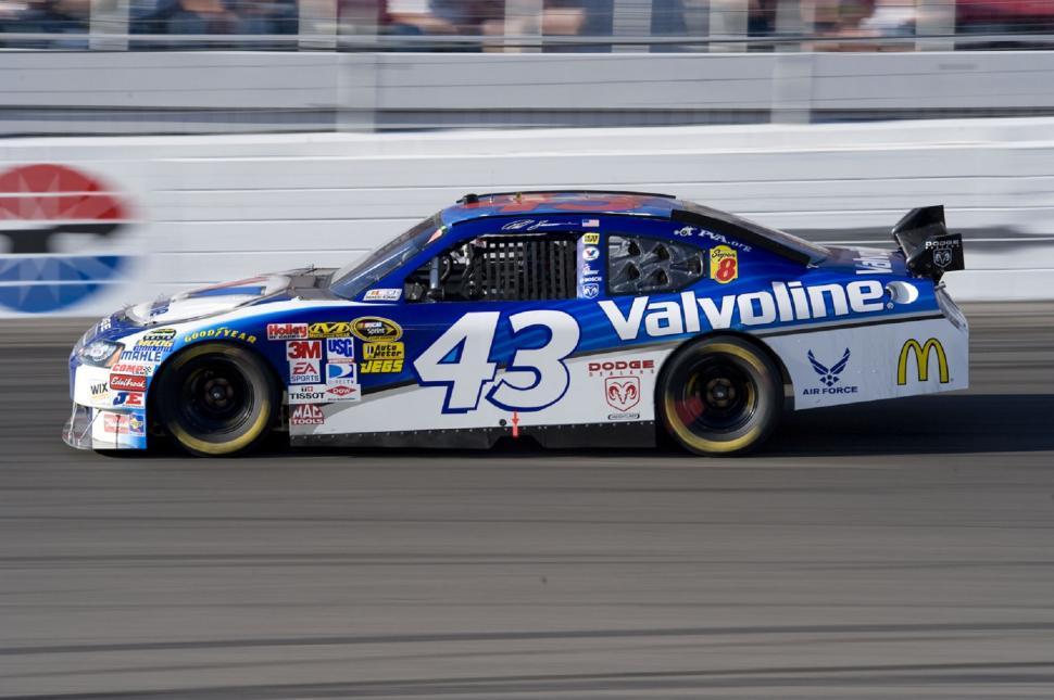 Free Image of Blue and White Car Racing on Track 