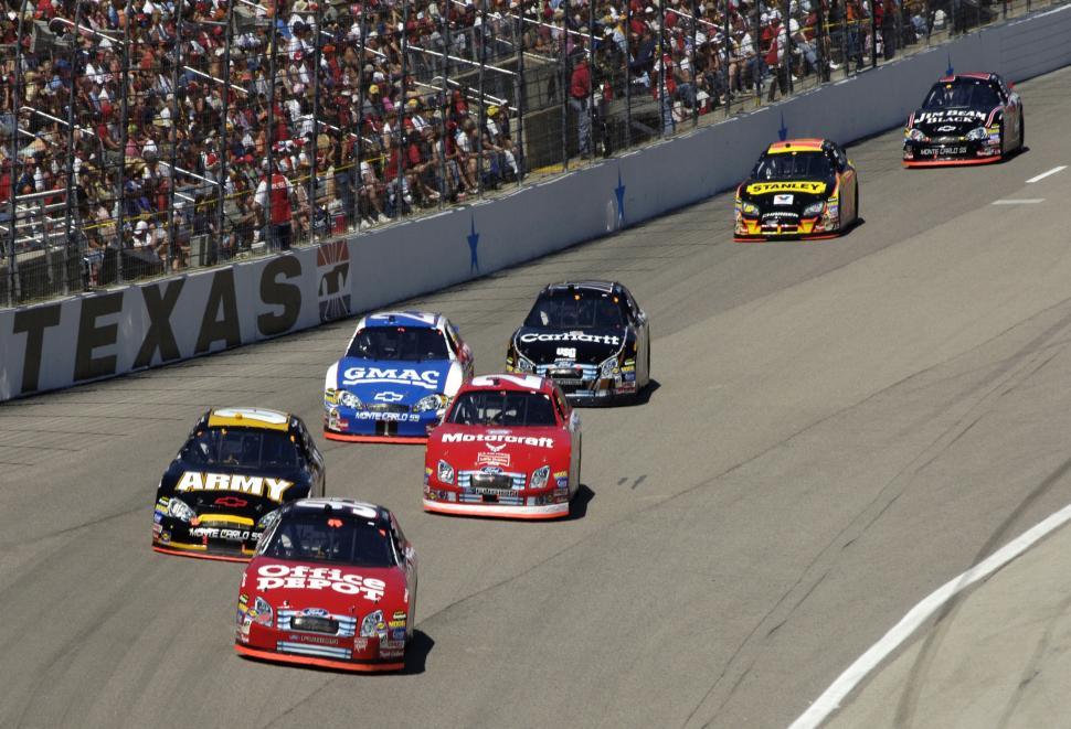 Free Image of Group of Cars Racing Down Track 
