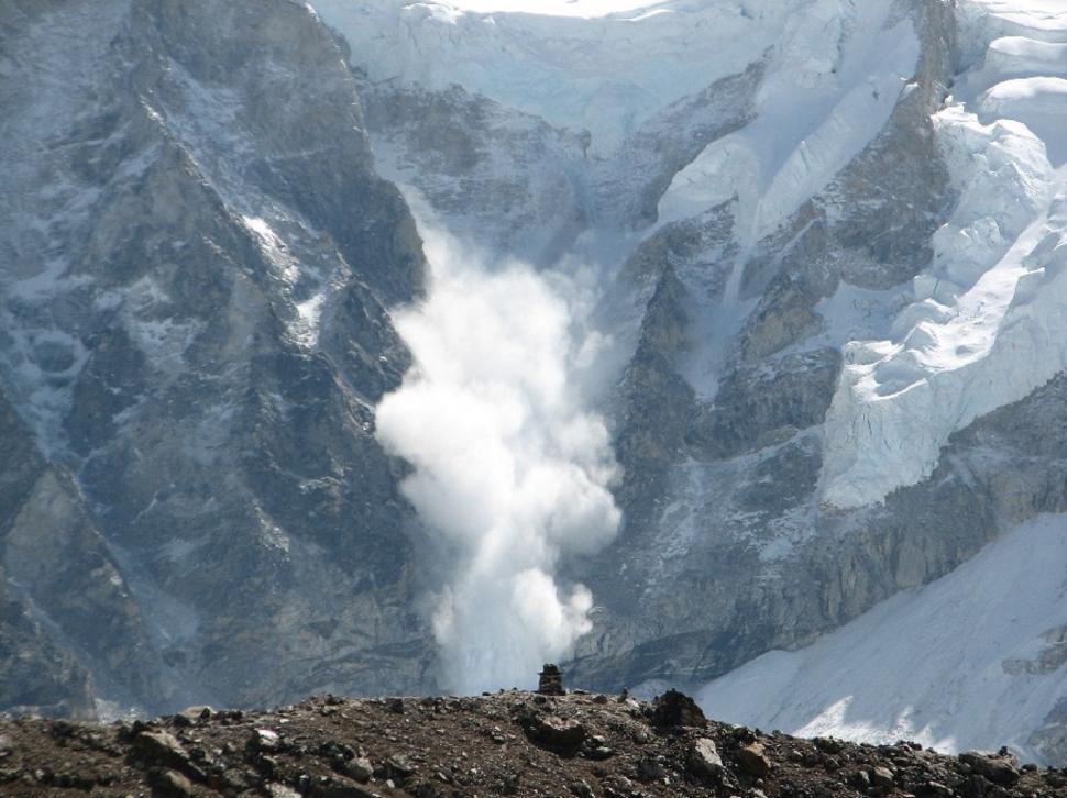 Free Image of Man Standing on Top of Snow-Covered Mountain 