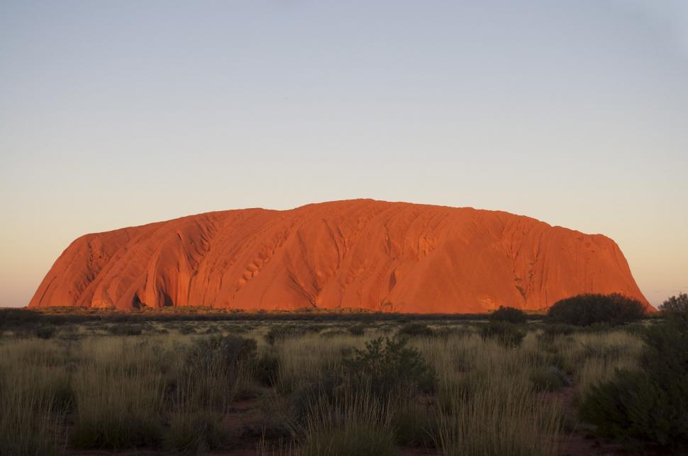 Free Image of Large Red Rock in Field 