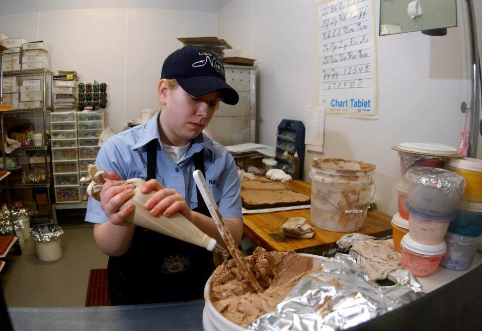 Free Image of Man in Blue Shirt Making Cake 
