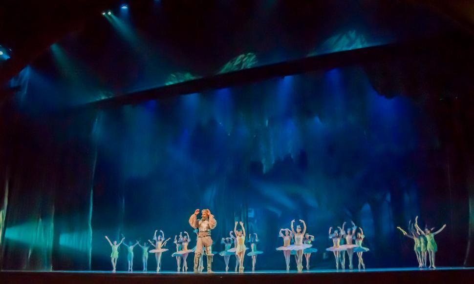 Free Image of Group of People Standing on Top of a Stage 