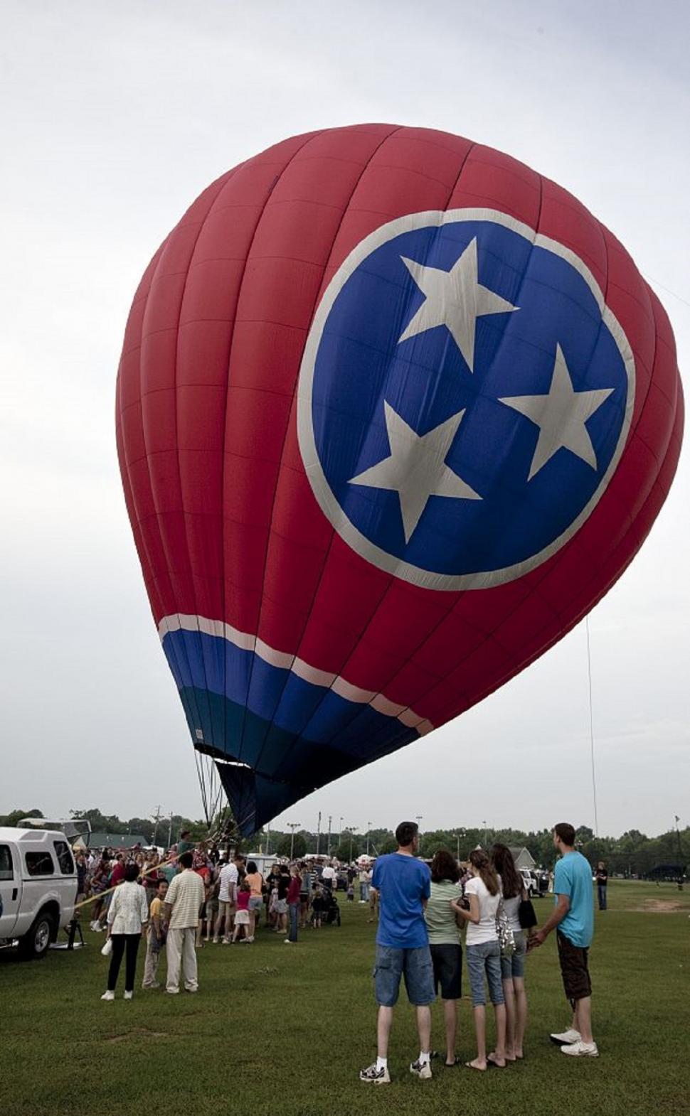 Free Image of Group of People Standing Around Hot Air Balloon 