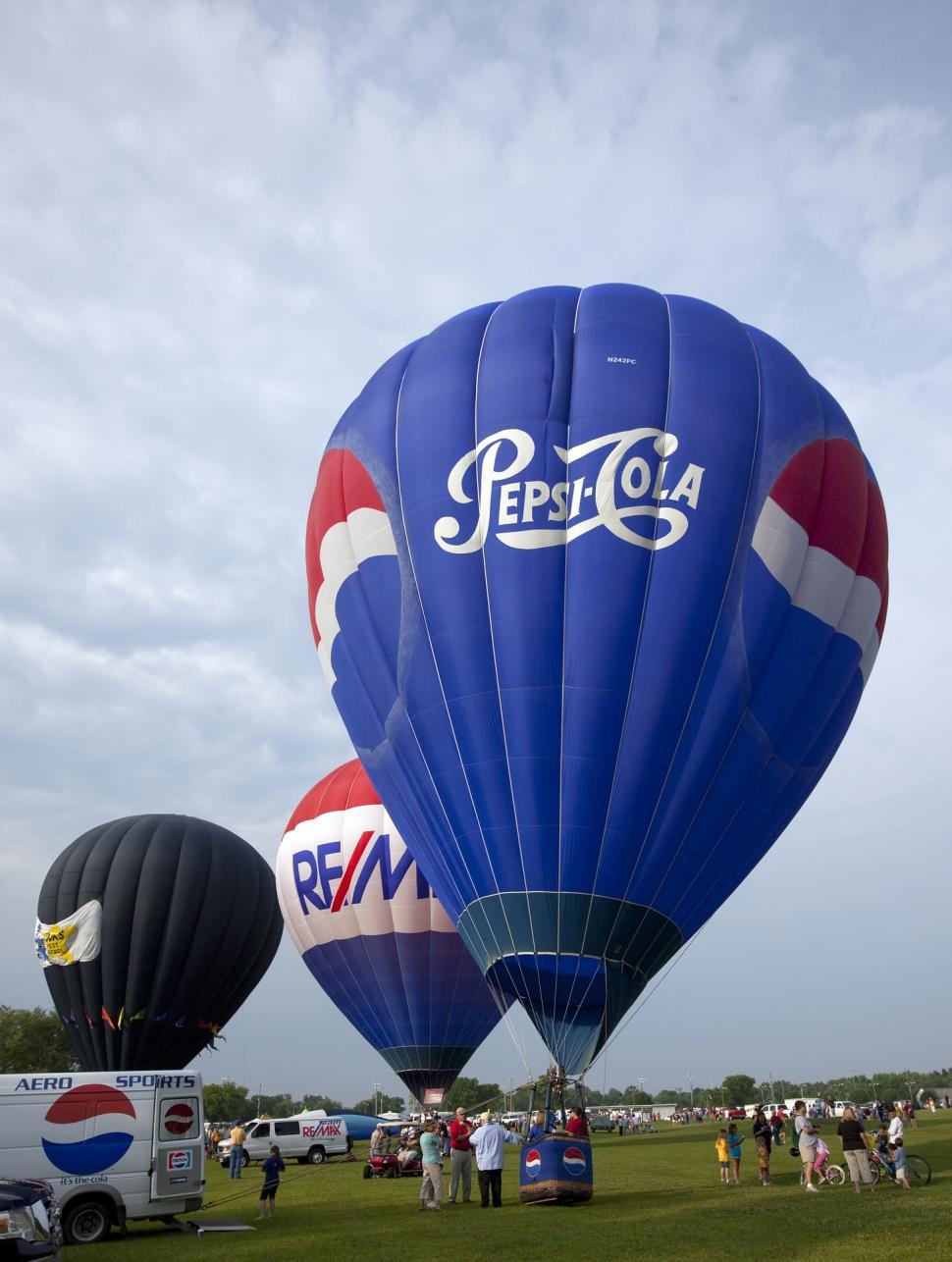 Free Image of Hot Air Balloons Resting in Field 